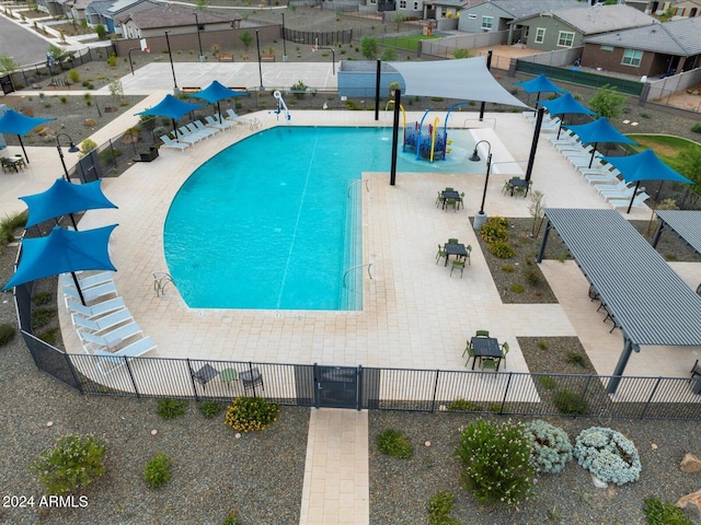 pool with a water play area and fence