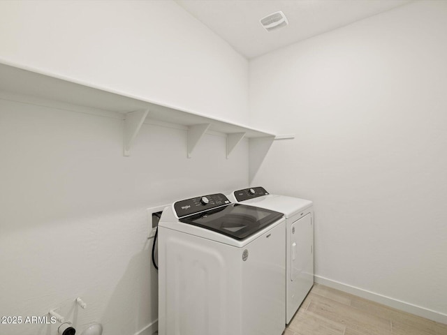 washroom with visible vents, light wood-style floors, laundry area, independent washer and dryer, and baseboards