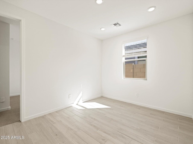 spare room with baseboards, visible vents, wood finished floors, and recessed lighting