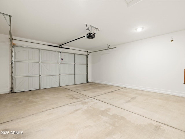 garage featuring a garage door opener and baseboards