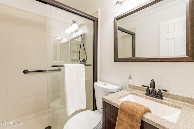 bathroom with vanity, toilet, and a shower with shower door