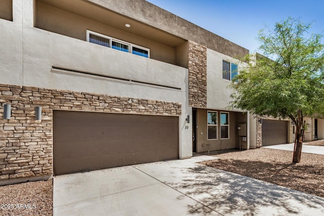 2000 N 36th St Unit 30, Phoenix, AZ 85008 - view of front of house with stone siding, driveway, and a garage