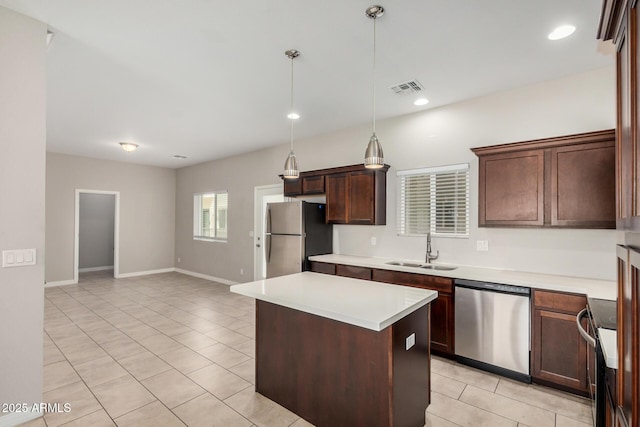 2000 N 36th St Unit 30, Phoenix, AZ 85008 - kitchen with stainless steel appliances, light tile patterned floors, a center island, light countertops, and pendant lighting
