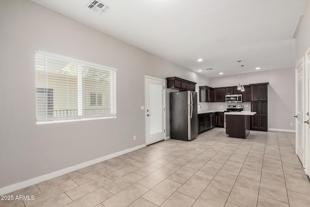 2000 N 36th St Unit 30, Phoenix, AZ 85008 - kitchen with appliances with stainless steel finishes, light countertops, dark brown cabinets, light tile patterned floors, and recessed lighting