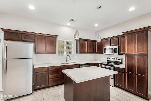2000 N 36th St Unit 30, Phoenix, AZ 85008 - kitchen featuring appliances with stainless steel finishes, light tile patterned floors, dark brown cabinets, light countertops, and recessed lighting