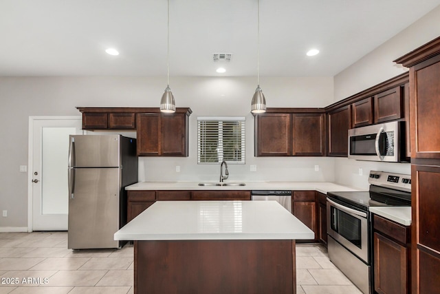 2000 N 36th St Unit 30, Phoenix, AZ 85008 - kitchen featuring stainless steel appliances, light tile patterned floors, light countertops, dark brown cabinets, and recessed lighting