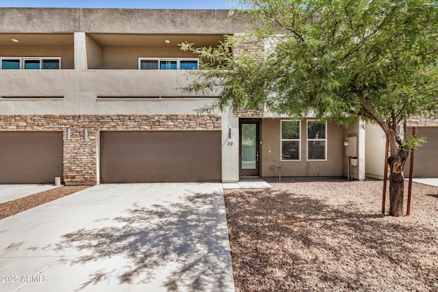 2000 N 36th St Unit 30, Phoenix, AZ 85008 - view of front of property featuring concrete driveway, stucco siding, a garage, and a balcony