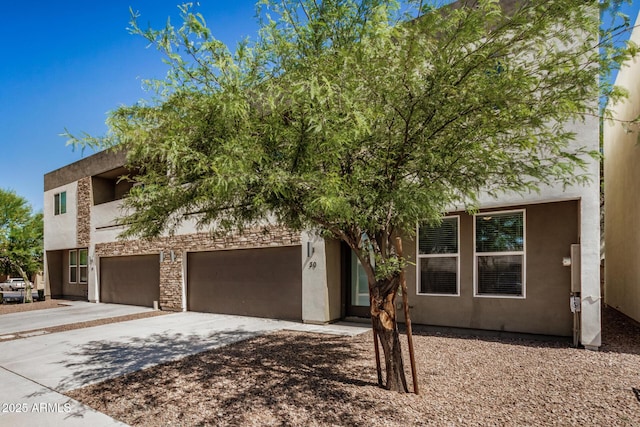 2000 N 36th St Unit 30, Phoenix, AZ 85008 - view of front of property featuring concrete driveway, a garage, and stucco siding