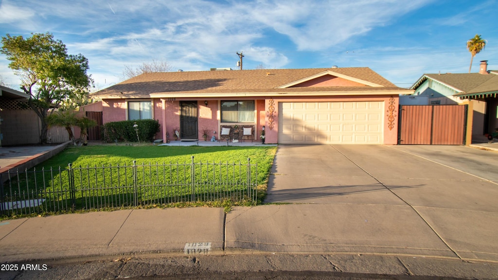 ranch-style home featuring a garage and a front yard