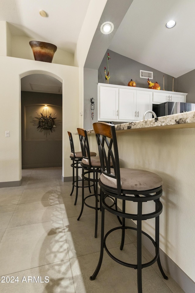 dining space featuring lofted ceiling