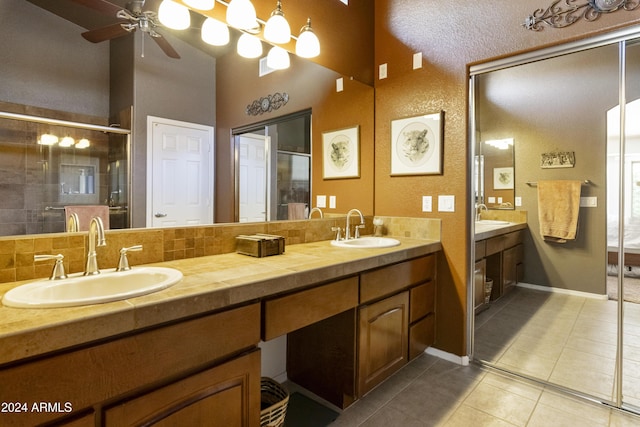 bathroom featuring ceiling fan, tile patterned flooring, a shower with door, and vanity