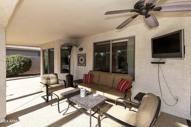 view of patio with an outdoor living space and ceiling fan