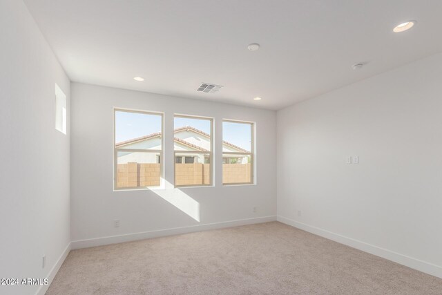 empty room featuring light carpet