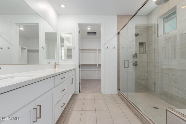 21354 E Sparrow Dr, Queen Creek, AZ 85142 - full bath with double vanity, a sink, a walk in closet, and a stall shower