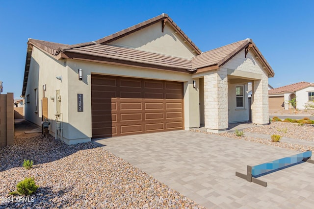 21354 E Sparrow Dr, Queen Creek, AZ 85142 - view of front of house featuring a tiled roof, stucco siding, an attached garage, and driveway