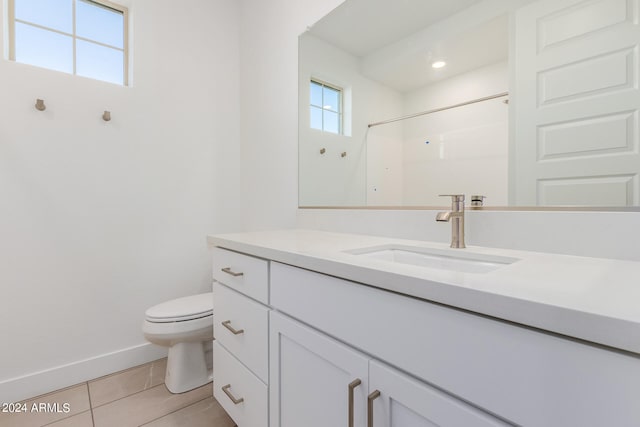 bathroom with vanity, toilet, a shower, and tile patterned flooring