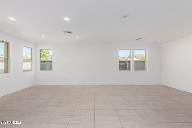 tiled empty room with a wealth of natural light