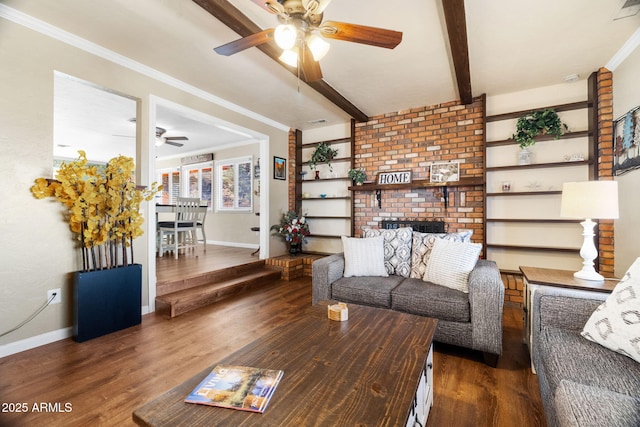 living room with beamed ceiling, ceiling fan, ornamental molding, and dark wood-type flooring