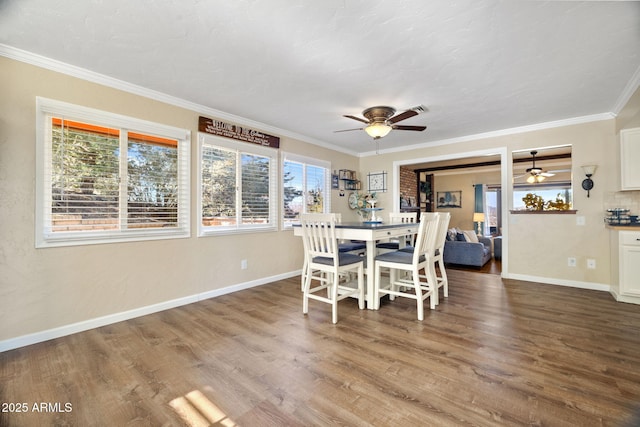 dining space featuring ceiling fan, ornamental molding, and hardwood / wood-style floors