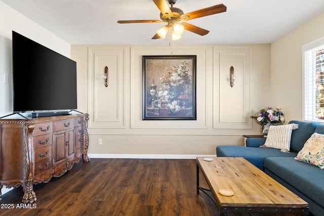 living room with dark wood-type flooring and ceiling fan