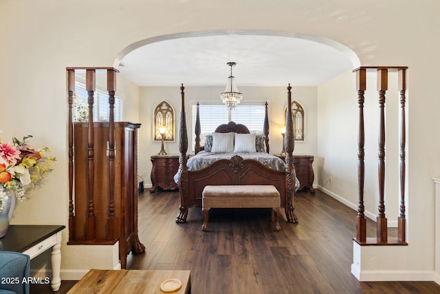 bedroom featuring dark hardwood / wood-style floors and an inviting chandelier