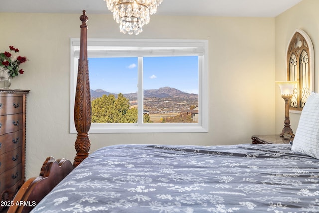 bedroom featuring a mountain view and an inviting chandelier