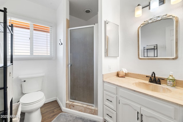 bathroom featuring vanity, toilet, an enclosed shower, and hardwood / wood-style floors