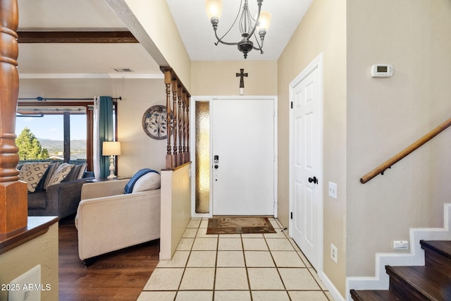 entrance foyer featuring a notable chandelier and light hardwood / wood-style flooring