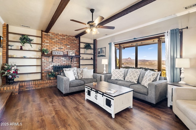 living room featuring a brick fireplace, crown molding, dark hardwood / wood-style floors, and beamed ceiling