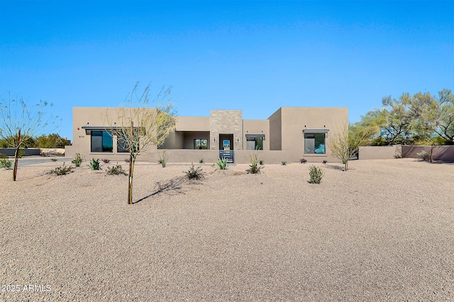 southwest-style home with fence private yard and stucco siding