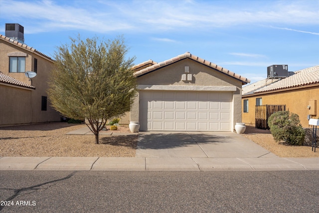 view of front of house featuring cooling unit and a garage