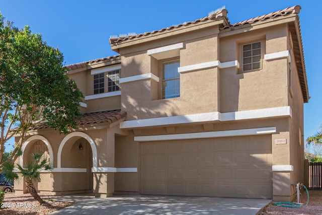 3064 E Michelle Way, Gilbert, AZ 85234 - mediterranean / spanish house featuring stucco siding, a tiled roof, a garage, and concrete driveway