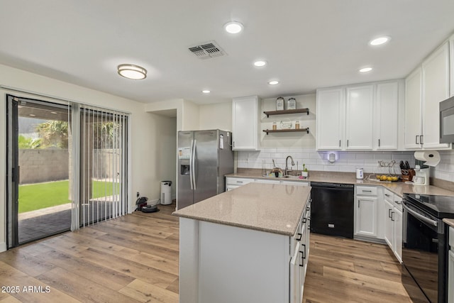 3064 E Michelle Way, Gilbert, AZ 85234 - kitchen featuring black appliances, a kitchen island, backsplash, light wood finished floors, and recessed lighting
