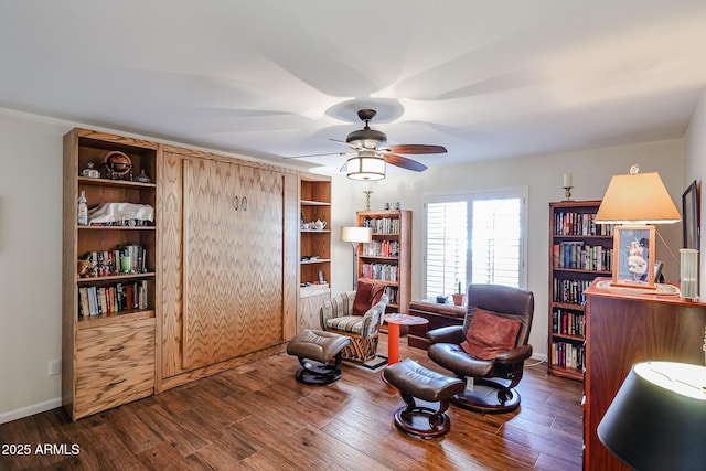 living area with ceiling fan, wood finished floors, and baseboards