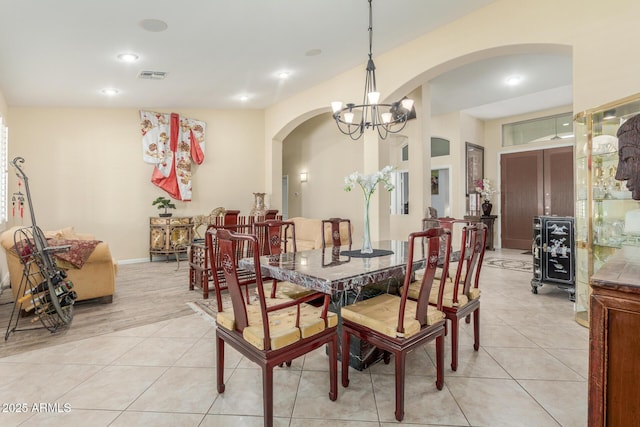 dining room with visible vents, recessed lighting, an inviting chandelier, arched walkways, and light tile patterned floors
