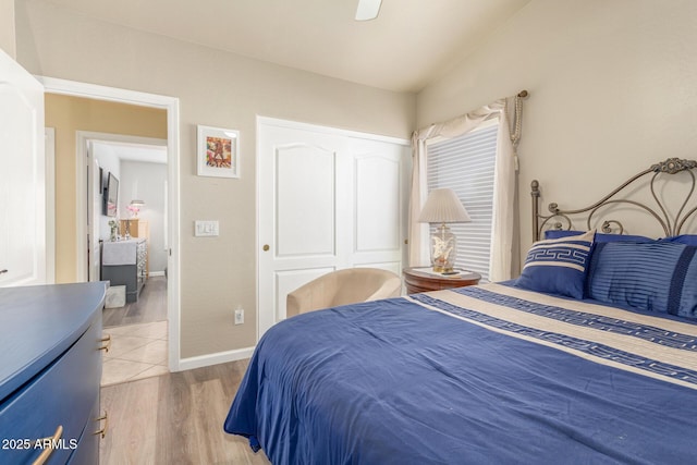 bedroom featuring baseboards, a closet, light wood-type flooring, and a ceiling fan