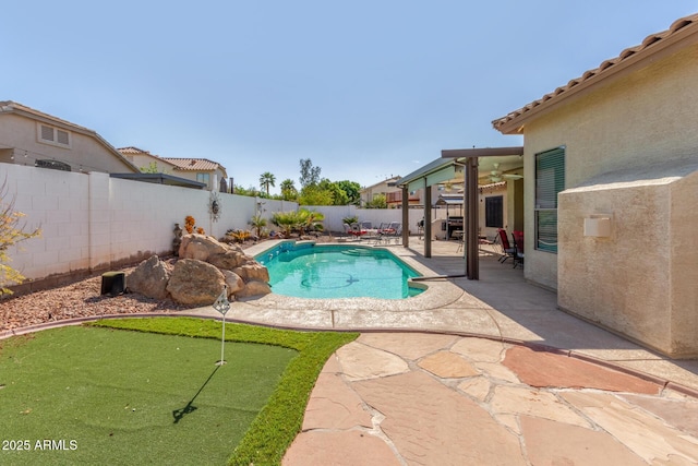 view of swimming pool with a patio, a fenced in pool, a ceiling fan, and a fenced backyard