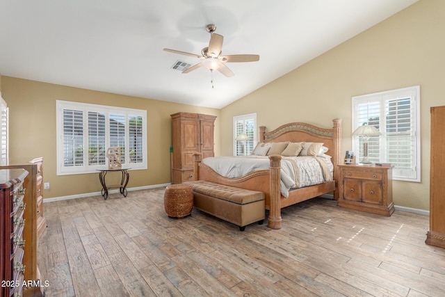 bedroom with lofted ceiling, baseboards, light wood-style flooring, and visible vents
