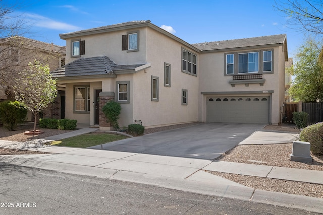 traditional-style home featuring stucco siding, driveway, fence, a garage, and a tiled roof