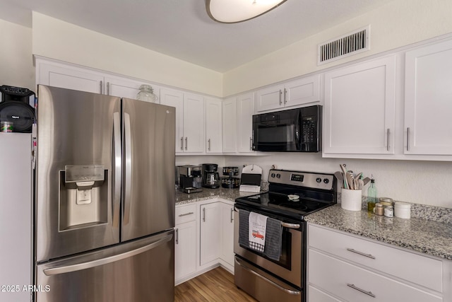 3447 E Dolphin Ave, Mesa, AZ 85204 - kitchen featuring stainless steel appliances, white cabinets, light stone countertops, and light wood-type flooring