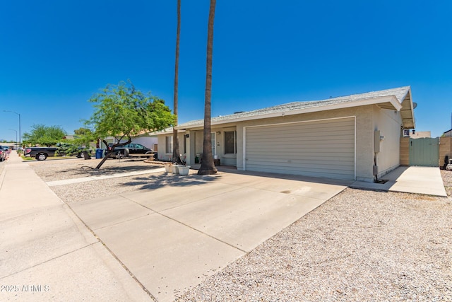 3447 E Dolphin Ave, Mesa, AZ 85204 - ranch-style house featuring an attached garage, driveway, a gate, and stucco siding