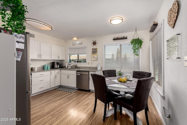 3447 E Dolphin Ave, Mesa, AZ 85204 - kitchen featuring appliances with stainless steel finishes, white cabinets, light wood-style flooring, and light stone counters