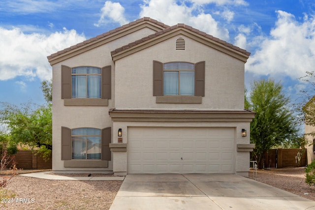 mediterranean / spanish-style home with a garage