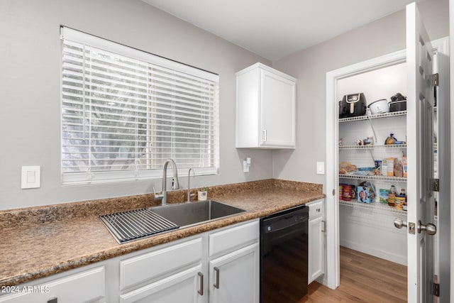 kitchen featuring dishwasher, light hardwood / wood-style floors, white cabinets, and sink