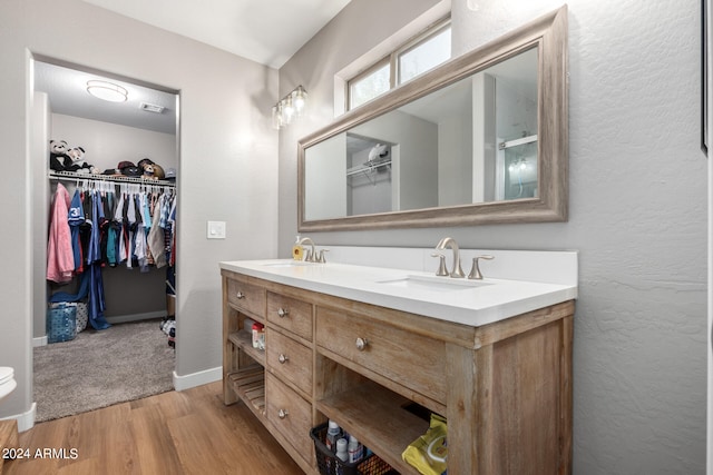 bathroom featuring an enclosed shower, hardwood / wood-style floors, and vanity