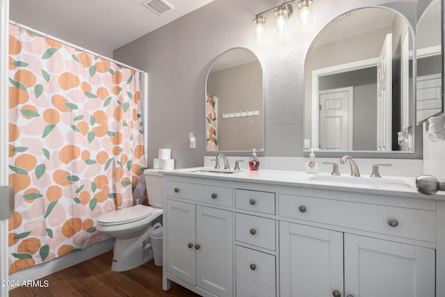 bathroom with toilet, walk in shower, vanity, and wood-type flooring