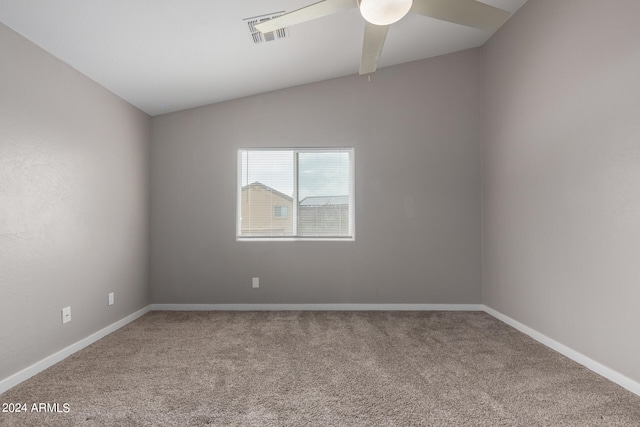 carpeted empty room with lofted ceiling