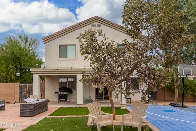 rear view of property with an outdoor living space and a patio area