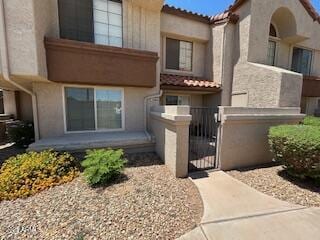 view of front facade with a fenced front yard and stucco siding