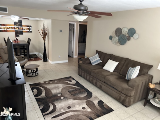 living area with visible vents, baseboards, ceiling fan, and tile patterned flooring